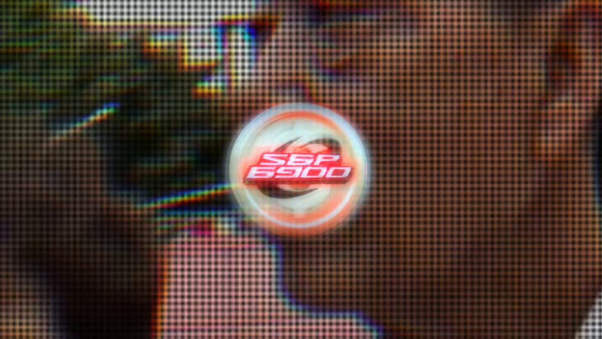 The image features a man with a red circle on his face that says "SFF 8000". The background of the image is black and white, which makes the red circle stand out even more. There are two other people partially visible at the bottom left corner of the image.