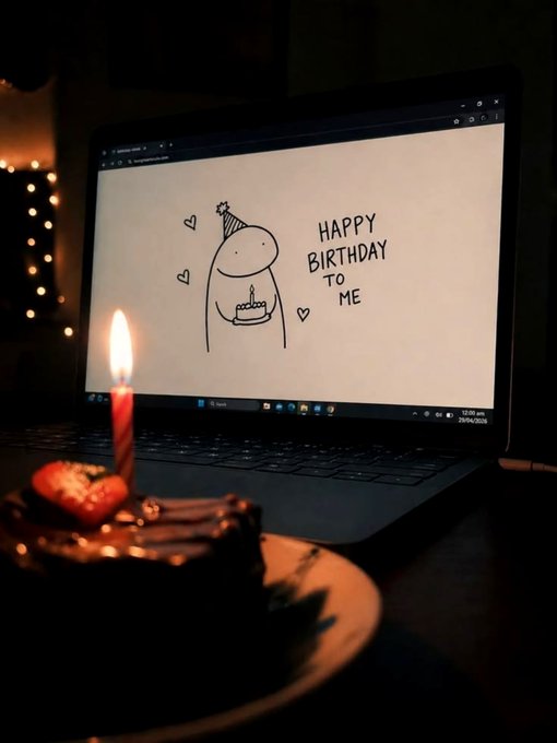 A laptop displays a hand-drawn 'HAPPY BIRTHDAY TO ME' doodle with a candle-lit dessert in the foreground.