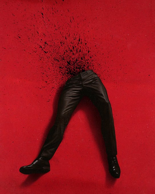 A pair of black leather pants and shoes stands on a red surface, but the upper body is missing, having disintegrated into a spray of black particles.