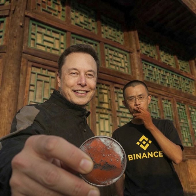 Two men pose in front of ornate green latticed wooden doors, with one smiling and holding out a red Mars-themed coin toward the camera, while the other wears a black "BINANCE" t-shirt and smokes. The image ties into the "Mission Marscoin" post by visually showcasing the commemorative coin being presented.