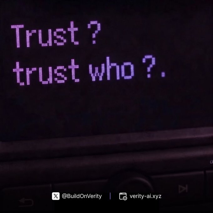 A close-up of a car dashboard display reading "Trust? trust who?" in pink text, with handles for @BuildOnVerity and verity-ai.xyz.