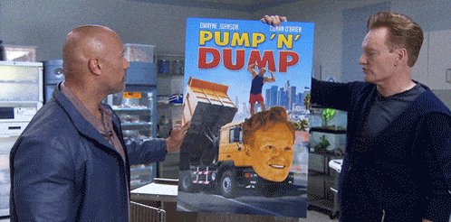 The image features two men standing next to each other, one holding a poster of a man's face while the other looks at it. The poster has the words "Pump 'n' Dump" written on it. The background shows an office setting with various objects such as refrigerators and a sink. There is also a sign that reads "Focus on what is in the image and how it relates to the post".