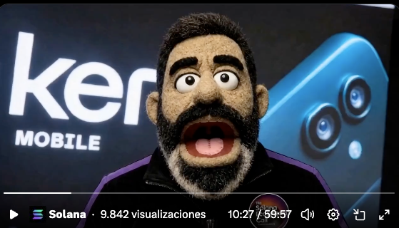 The image features a cartoon character with a beard, wearing a black jacket, standing next to a blue box that says "Kerner Mobile" written on it. The character appears to be making an exaggerated facial expression or gesture as if they are surprised by something in front of them.