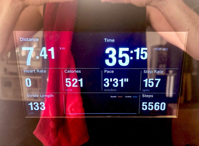 A glass trophy or acrylic award displays workout stats from a treadmill run: 7.41 km in 35:15, with 521 kcal burned, a pace of 3'31"/km, and 5,560 steps. The post's "Can't Stop, Won't Stop" motto ties to both the dedication of completing a 7.41 km run and the relentless energy behind $GME GameStop stock, while the bright red cloth draped over the award visually echoes the bullish red associated with the meme stock movement.