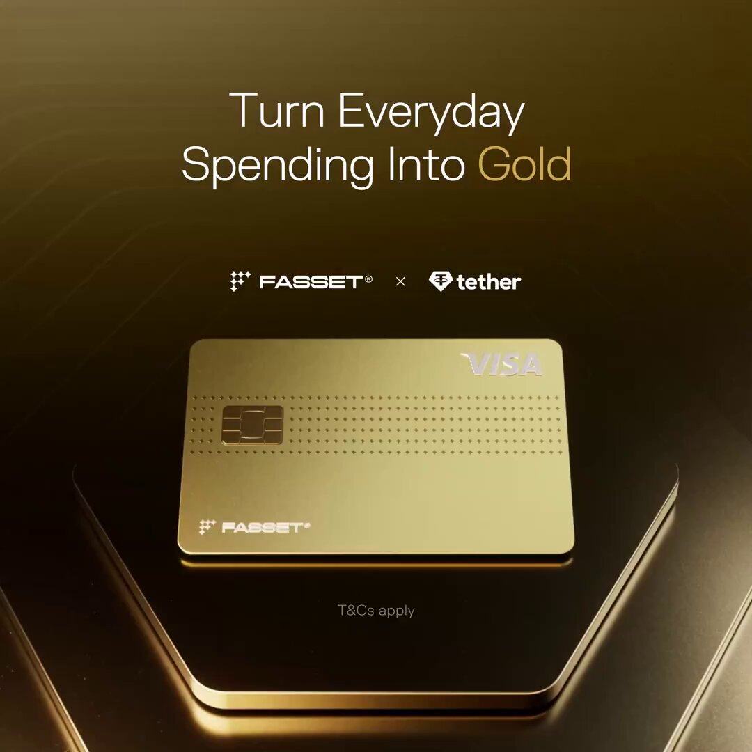 The image features a gold Visa card with the words "Tether" and "Fasset" written on them, suggesting that they are collaborating together for this project. The gold credit card emphasizes its value as an investment into gold due to its association with a stable currency like Bitcoin or Tether Gold. Users can spend their dollars at any Visa location, and for every dollar spent, the card will automatically invest up to six% cashback in Tether Gold, providing users with a unique opportunity to save on everyday spending.