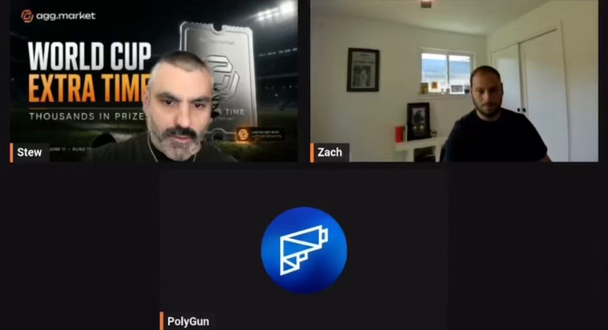 The image shows two men sitting at their computers, engaged in a video call with each other. They are both wearing black shirts and appear to be discussing something related to sports or a competition. The background of the image features a white wall with a window on the right side. There is also an orange logo visible in the top left corner of the screen.