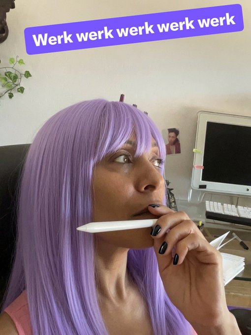 A woman with a purple wig and black nail polish holds a white stylus pensively in her mouth, with a purple banner reading 'Werk werk werk werk' overlaid on the image.