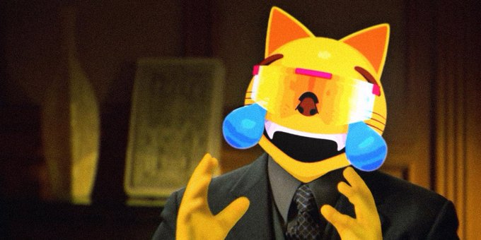 A yellow cartoon cat emoji head with blue tear drops is edited onto a person in a dark suit and tie, gesturing with yellow cartoon hands against a dim background.