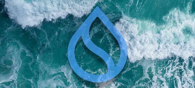A blue water drop logo containing an 'S' shape is centered over a background of crashing turquoise ocean waves.