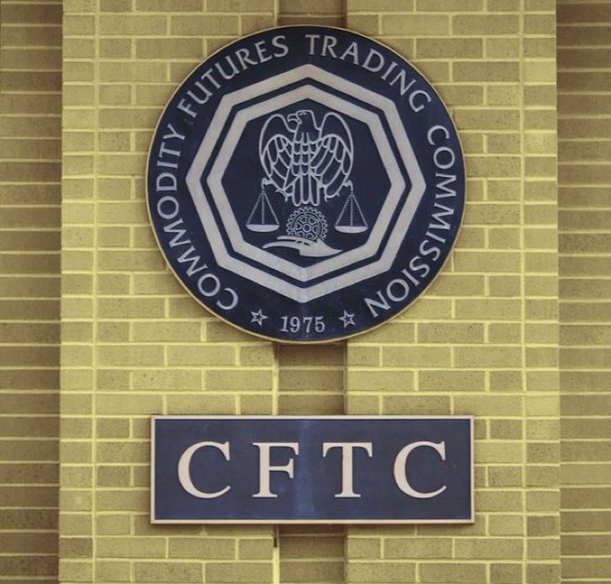 The official seal of the Commodity Futures Trading Commission (CFTC), founded in 1975, is mounted on a brick wall above a sign bearing the acronym 'CFTC'.