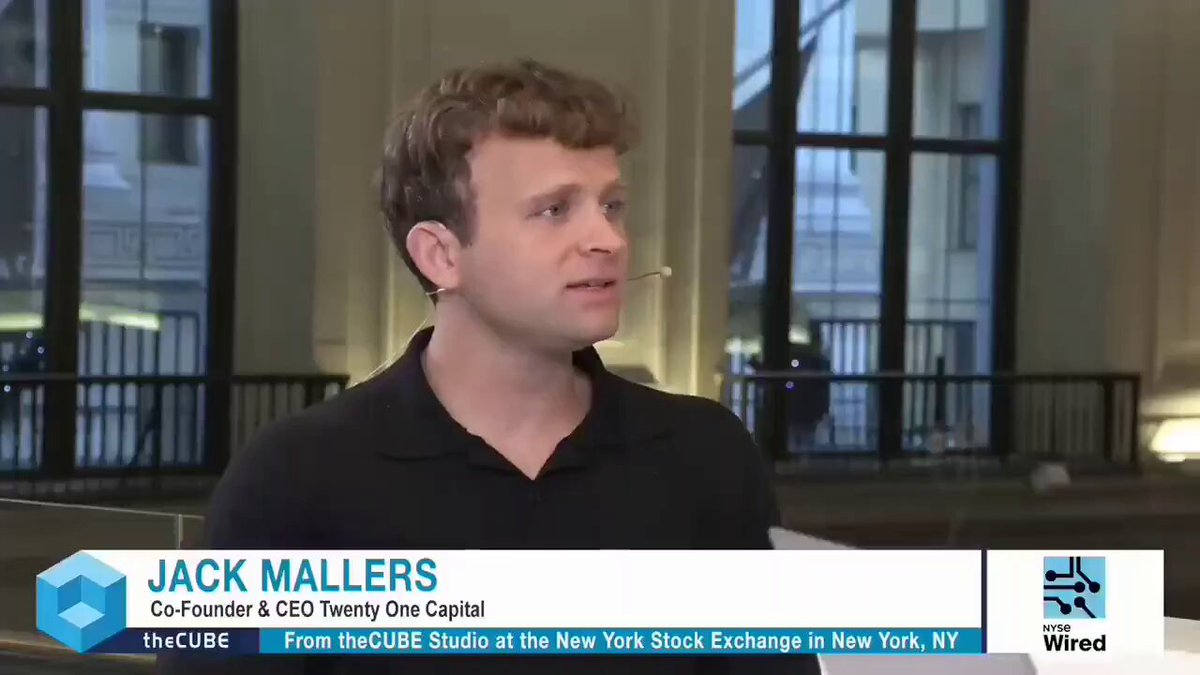 The image features a man wearing a black shirt, standing in front of a window with a white background. The man appears to be talking or giving a speech, as indicated by his facial expression. In the background, there are two windows that can be seen clearly. The text "Jack Mallers" is written on the image, and it seems like the post was taken from a website called "Focus on".