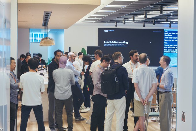 A networking event in Tokyo, as indicated by the "Lunch & Networking" signage from WooFiNet, captures attendees engaged in conversation—reflecting Ethereum Foundation's Asia tour across Tokyo, Seoul, and Singapore. The image illustrates the post's theme of institutional dialogue, showing participants connecting over shared discussions about Ethereum's role in finance.

Keywords: Event Photography, Conference Networking, Ethereum Foundation, Asia Tour, Tokyo, Seoul, Singapore, WooFiNet, Lunch & Networking

*Note: The "Tokyo. Seoul. Singapore." text appears in the post rather than being directly visible in the image itself.*