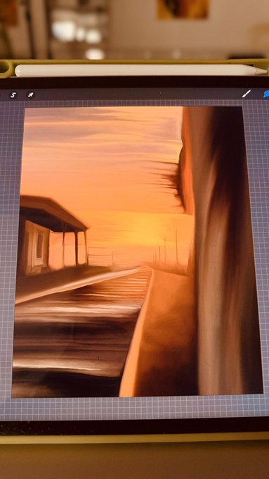 A tablet displays a digital painting of a sunset landscape with warm orange tones, accompanied by an Apple Pencil resting on top. The caption "Gm Loading 80% Next drop for fragments will release this week .01 E" suggests the artist is teasing an upcoming digital art release, with the painting serving as a preview of the "fragments" artwork collection.