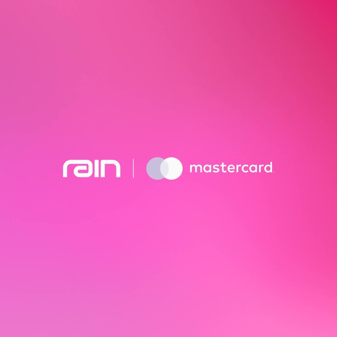 The image features a logo for Rain which incorporates two dollar bills stacked vertically next to each other. The dollar bills are rendered in white color, and both of them have a round shape with a hole in the center. The background of the logo is a soft pink color, providing a pleasant contrast to the stark white of the dollar bills. Below the logo, there is text that reads "Rain vs Mastercard", indicating a comparison between Rain's currency symbol and Mastercard.