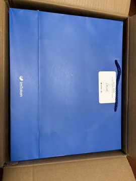 The image shows an open box containing a blue gift bag with a white label that reads "imToken 10th Anniversary Gift Box!". The gift bag appears to be a wallet, which is related to the Web3 platform. The text on the label indicates that this gift is for someone who has been using imToken and is now celebrating its 10th anniversary.