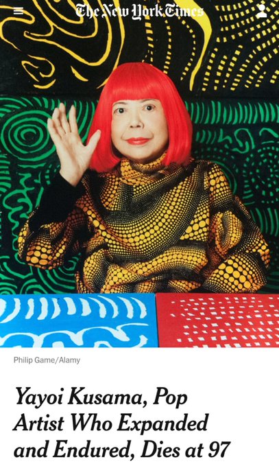 A New York Times article cover featuring an elderly woman with bright red hair and bold red lipstick, wearing a yellow polka-dot patterned outfit against a vibrant psychedelic background. The headline reads "Yayoi Kusama, Pop Artist Who Expanded and Endured, Dies at 97," with the photo credited to Philip Game/Alamy.