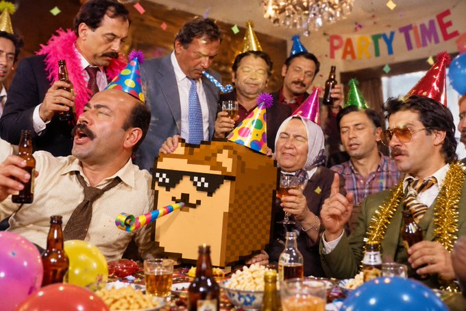 A group of people in party hats celebrate at a 'PARTY TIME' event, with one person in the center wearing a pixelated Doge coin head mask and holding a party blower.