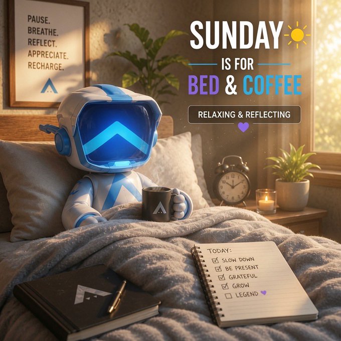 A cozy digital artwork of a blue and white robot wearing a helmet sitting in bed holding a mug, with a "PAUSE. BREATHE. REFLECT. APPRECIATE. RECHARGE." poster on the wall and text overlay reading "SUNDAY IS FOR BED & COFFEE".