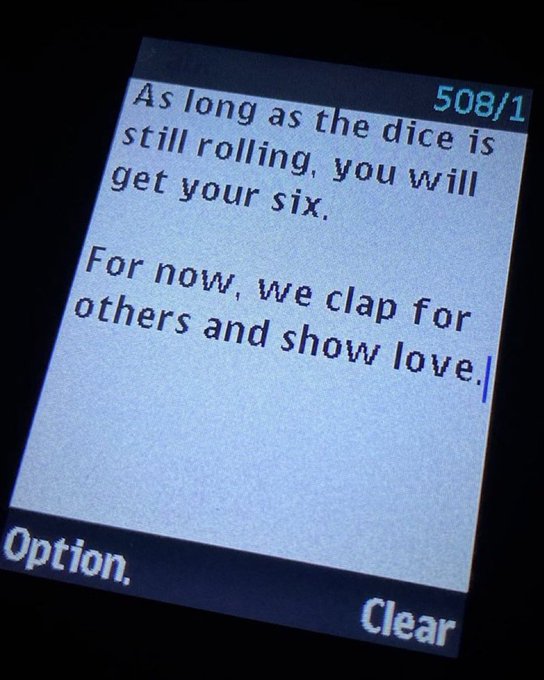 A close-up of a digital screen displaying text message '508/1' reading 'As long as the dice is still rolling, you will get your six. For now, we clap for others and show love.' with 'Option.' and 'Clear' buttons visible at the bottom.