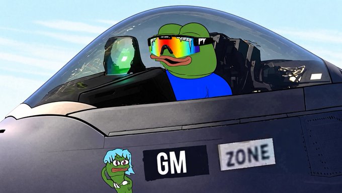 A Pepe the Frog meme character wearing rainbow sunglasses and a blue shirt sits in the cockpit of a fighter jet marked 'GM ZONE', with a smaller Pepe character below.