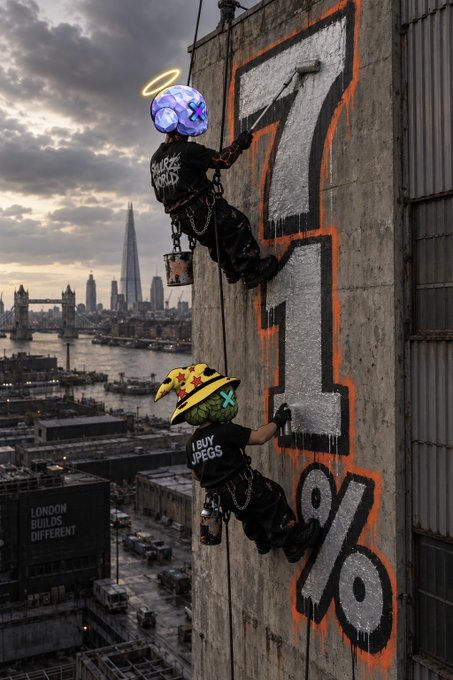 A digital artwork showing two figures with animalistic and angelic heads (one with a halo) hanging from ropes as they paint a large "7" and "%" symbol in orange and white on a building, with the London skyline visible in the background and a "LONDON BUILDS DIFFERENT" sign.