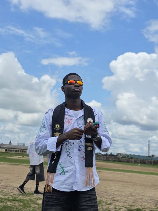A young man stands outdoors wearing reflective orange sunglasses and a white shirt covered in handwritten signatures, holding what appears to be a cigar. Visible text on his scarf includes "EDMOND," "JUSTIN," and "2020," suggesting a celebratory moment—likely the graduation or milestone referenced in the post's request for congratulations from MoonPay and Paybox.