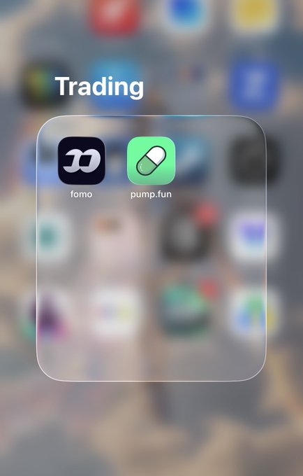 An iOS home screen folder labeled 'Trading' containing two app icons: 'fomo' (black background) and 'pump.fun' (green background with a pill icon).