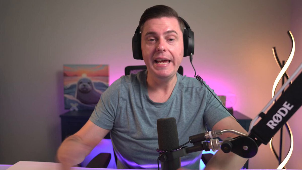 The image shows a man sitting at a desk with headphones on his head, wearing a gray shirt. He appears to be talking into a microphone or headset while seated behind a desk. The background features a painting of a seal, which adds an artistic touch to the scene. The caption above the image reads "MAJOR: Ripple is building far more than payments Ripple is bringing payments, custody, stablecoins, tokenization, treasury management, and liquidity infrastructure as institutional interest in digital assets continues to grow". This suggests that Ripple's focus on digital asset-related services has grown significantly over time.