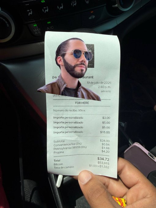 A restaurant receipt dated July 19, 2026 shows a $34.72 total paid in Bitcoin at a $53,915 exchange rate, held in a car with a man's face digitally edited onto the top.