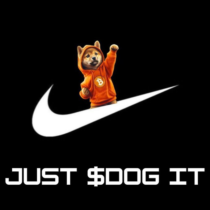 A Shiba Inu dog in an orange hoodie with a Bitcoin logo raises its fist in a Nike-style swoosh pose, with text reading 'JUST $DOG IT' on a black background.
