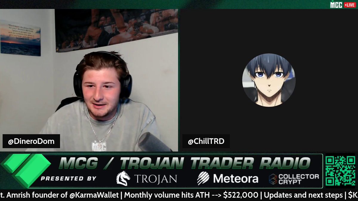 In this image, a man wearing headphones is seen talking into a video call. The video call is taking place through a screen displaying a chat window with a character from the video game Trojans Trader Radio. There are several other characters on the chat windows as well. A quote at the bottom of the image reads: "Today on MCG: @ColbySaysHi | @prism_lp | $PRISM is the first token where holding is providing liquidity." This indicates that the video call has a connection to an active gaming session, specifically a conversation related to the video game Trojans Trader Radio.