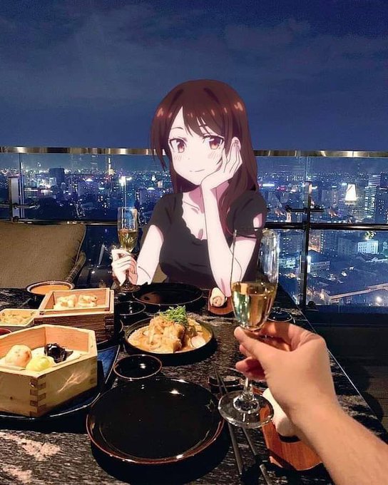 Anime-style illustration of a girl with brown hair and a black dress sitting at a dinner table with food, drinks, and a city night view in the background, with a real human hand holding a champagne glass in the foreground.