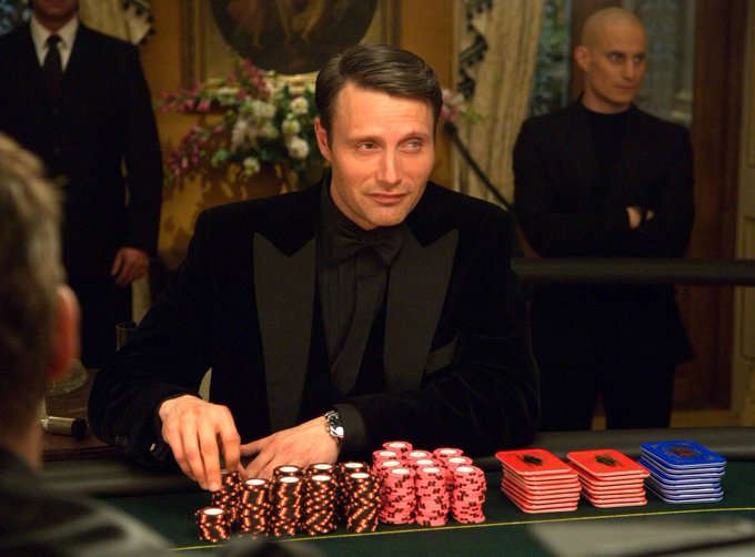 The image features Mads Mikkelsen's character Le Chiffre from the James Bond film "Casino Royale" seated at a poker table with stacks of chips, which serves as the accompanying visual for "Stockcoin is the best token for RWA...it works great for memes too."

The high-stakes poker setting suggests themes of risk, strategy, and substantial rewards—drawing a parallel to the bold claim of Stockcoin being a top token in the competitive crypto space.