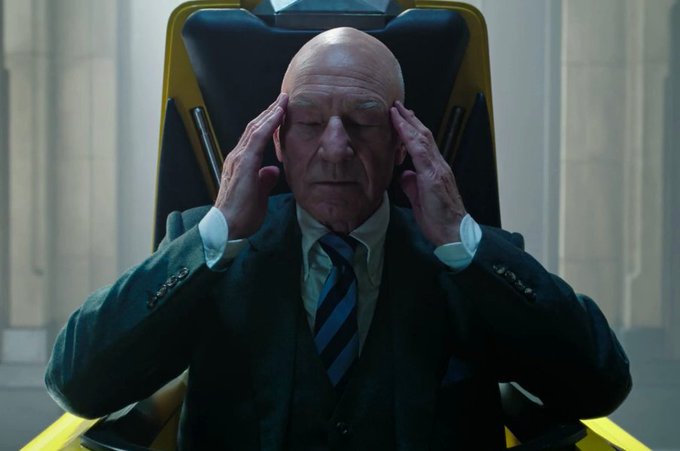 An older bald man in a dark suit and striped tie sits in a high-backed chair, pressing both hands to his temples with his eyes closed in deep concentration. The image humorously illustrates the post's caption about intense focus, as his furrowed brow and gripping gesture convey the exaggerated mental effort of "locking in."

The image appears to depict Professor Charles Xavier from the X-Men franchise, recognizable by his bald head and characteristic chair.