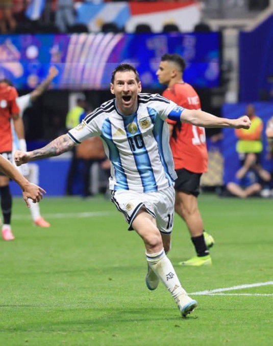 Lionel Messi wearing Argentina's number 10 jersey celebrating on the pitch during a match.