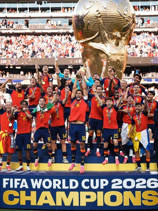 A celebratory image of a soccer team in red jerseys lifting the FIFA World Cup trophy, captioned 'FIFA WORLD CUP 2026 CHAMPIONS,' appearing to depict Spain's national team victory.