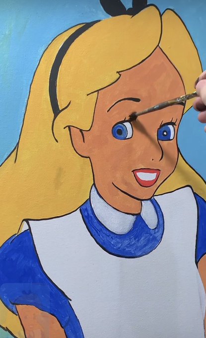 A partially completed painting of Alice from Alice in Wonderland, with an artist's brush adding details to her eyebrow.