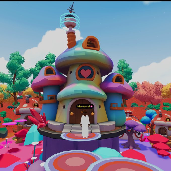 The image features a whimsical, colorful house with a tower that has a weather vane on top of it. The house appears to be located within a fantasy world or a video game setting. A person can be seen standing outside the house, possibly admiring its unique design and colors. The post is about a trippy day in this fantastical world, which adds an element of fun and creativity to the image.