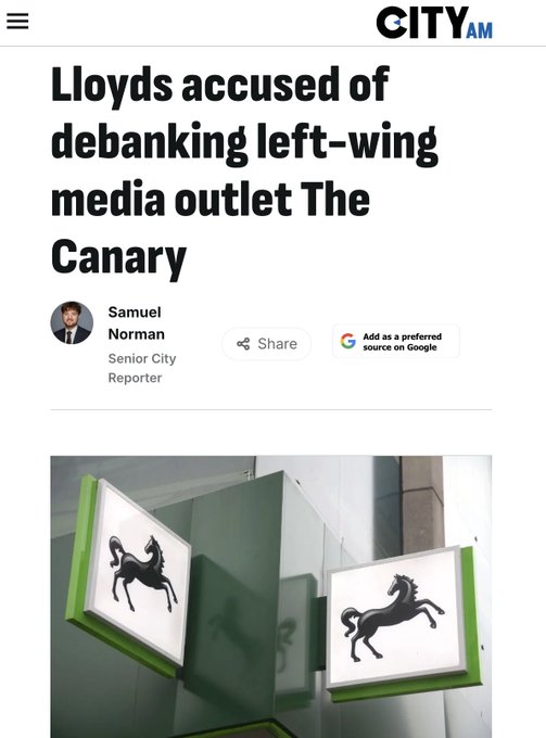 A headline from City AM reads: "Lloyds accused of debanking left-wing media outlet The Canary," credited to Senior City Reporter Samuel Norman. The photo below shows two illuminated Lloyds Bank signs featuring the company's black horse logo, visually linking the bank's brand to the debanking allegations that have ironically boosted the outlet's visibility.