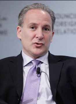 Peter Schiff, a well-known gold advocate and Bitcoin critic, is shown speaking at what appears to be a financial conference, with a lapel microphone visible against his suit and purple tie—visually aligning with his post claiming Bitcoin is trading as an "anti-gold" asset.