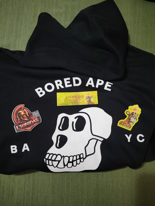 A black Bored Ape Yacht Club hoodie featuring a white skull graphic and the text 'BORED APE BA YC', decorated with three stickers including two labeled 'LEONIDAS'.
