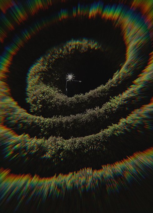An abstract dark spiral image with a small white star-like shape in the center, surrounded by radiating colorful streaks creating a tunnel effect.