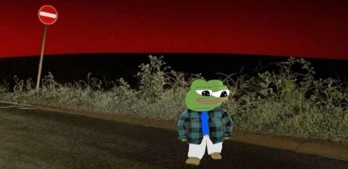 A Pepe the Frog character wearing a plaid shirt and blue tie stands on a road next to a no-entry traffic sign against a dark red sky.