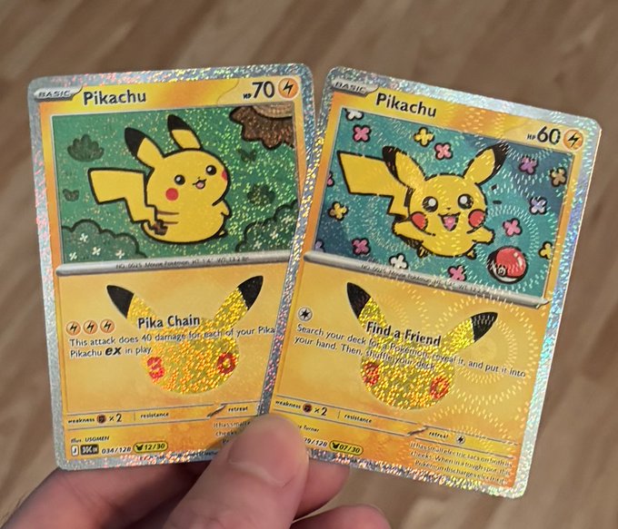 A hand holding two holographic Pikachu Pokémon trading cards, one featuring the 'Pika Chain' attack (70 HP) and the other featuring the 'Find a Friend' attack (60 HP).