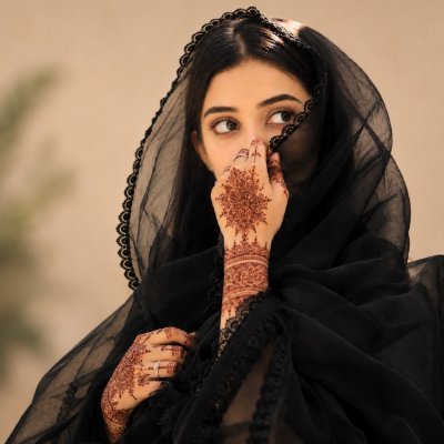 A woman wearing a black sheer dupatta covers her face with hands adorned in intricate henna (mehndi) designs, her expressive eyes peering over her fingertips in a shy, elegant pose.

The image's serene, contemplative mood pairs nicely with the post's reflective "goodnight" sign-off, while the delicate, detailed henna patterns echo the interconnected web of burns, ecosystem ties, and underlying structure the author appreciates about the $KNOTS project beyond just price action.
