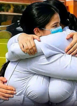 Two people share an emotional embrace, with one wearing a blue surgical mask, suggesting a moment of heartfelt connection. The image visually reinforces the post's invitation for a "heart-to-heart" discussion among Pi Network pioneers, emphasizing the close-knit, supportive nature of the community as they debate their understanding of the cryptocurrency.