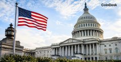 The image shows the U.S. Capitol building with the American flag, symbolizing the legislative branch of the government. This relates to the CoinDesk post because it highlights the delay in passing the CLARITY Act, a piece of crypto legislation.