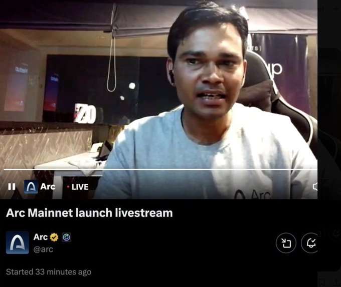 A man wearing a gray "Arc" shirt speaks during the "Arc Mainnet launch livestream" by @arc on X, which has been live for 33 minutes, apparently at the moment his face was exposed online, contributing to projects splitting away from the ARC protocol due to concerns about the developer Un Du and the undisclosed team.