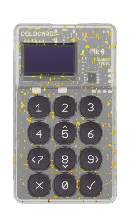 A product image of a Coinkite COLDCARD Mk4 Bitcoin hardware wallet featuring a transparent/yellow-speckled casing with a numeric keypad and small display screen.