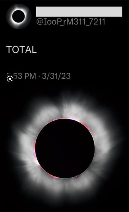 A total solar eclipse captured on March 31, 2023 at 8:53 PM, photographed by @IooP_rM311_7211, showing the moon completely blocking the sun and revealing its glowing corona with hints of pink/red solar prominences along the edges.